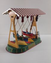 German mechanical clockwork lithographed tinplate fairground boat-swing toy by Josef Wagner. Working