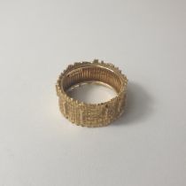An Andrew Grima 18ct gold tree bark design wide band ring, weighing 8g, size Q. Shipping Group (A).