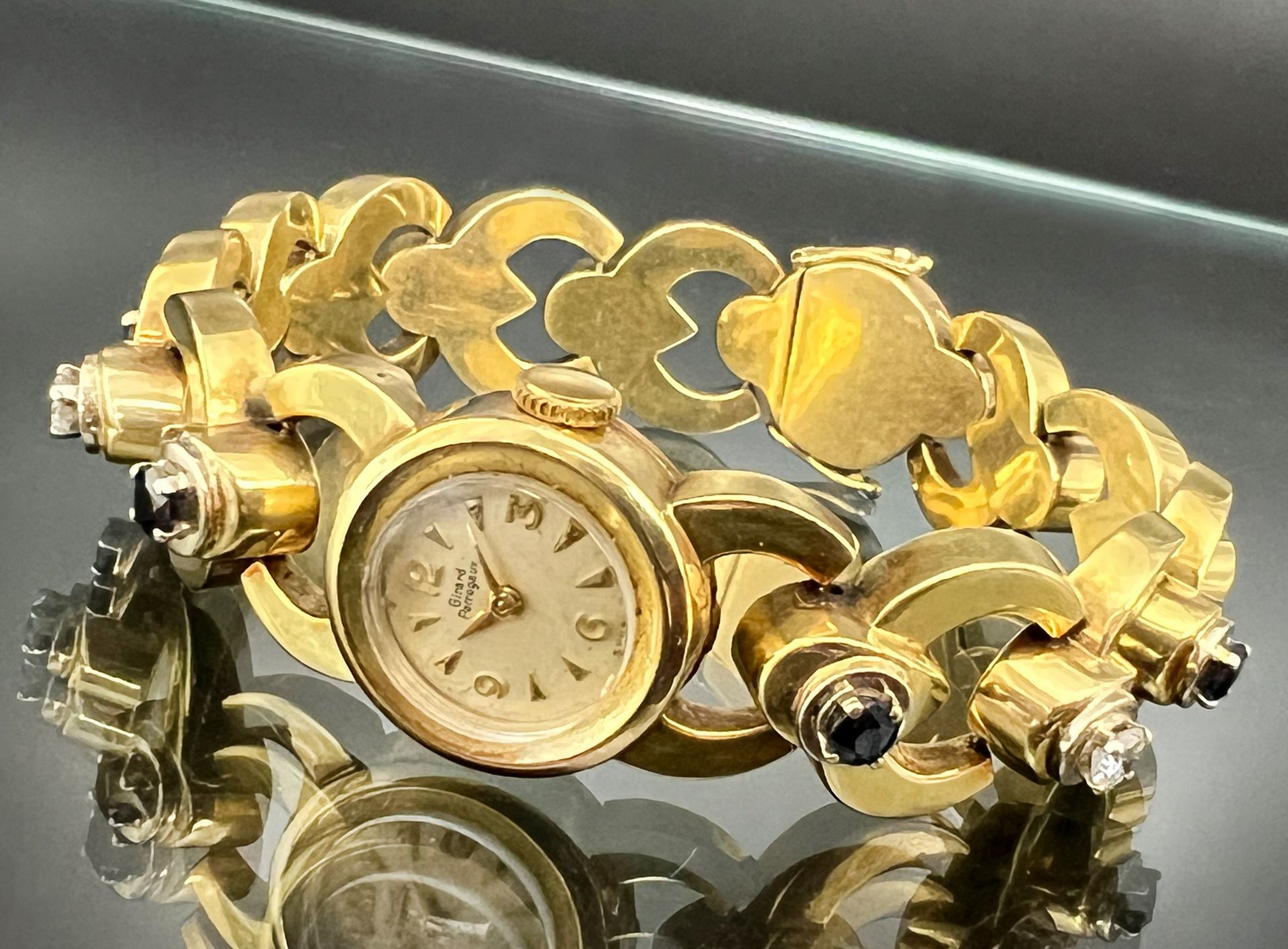 GIRARD-PERREGAUX ladies' wristwatch. 585 yellow gold with 2 diamonds and 4 sapphires.