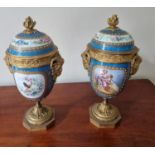 A really good pair of 19th Century hand painted Urns with lids with ormolu rams head sides on plinth