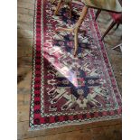 A handwoven Turkish Kars Kazakh Rug with a sunburst design.