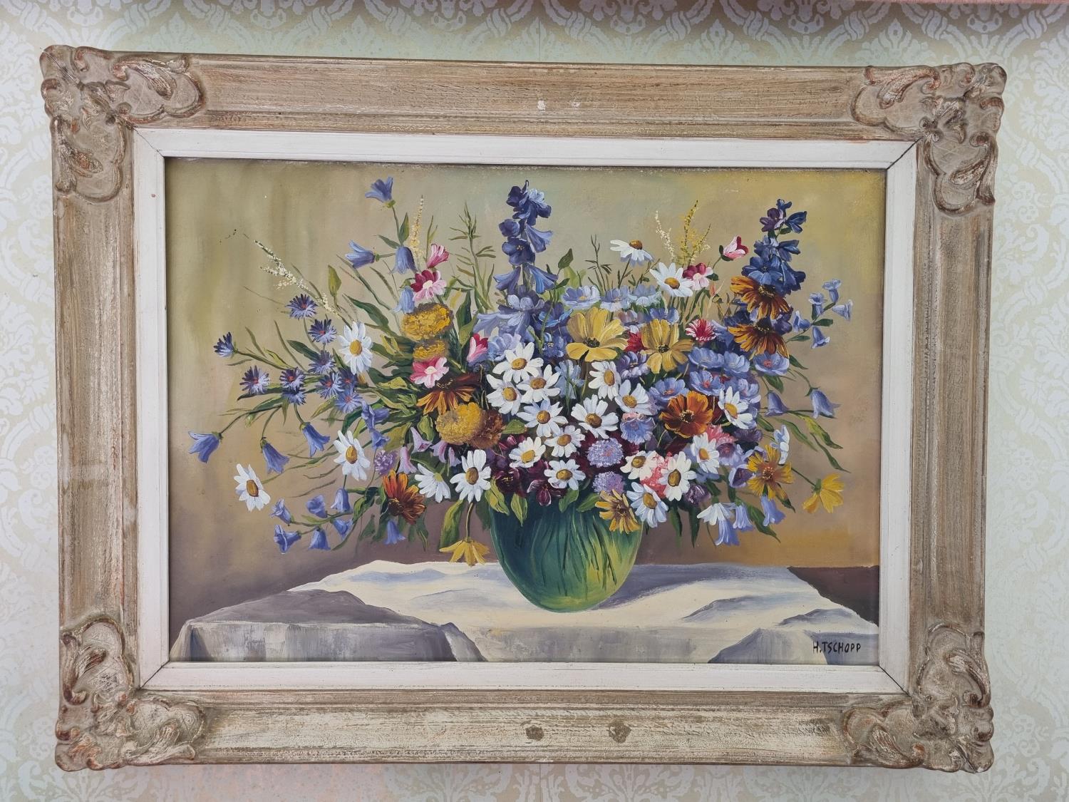 A 20th Century Oil on Canvas still life of wild flowers in a vase on a table setting. Indistinctly