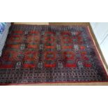 A good red ground Rug with repeating central medallion design and multi borders. 253 x 155cm approx.