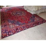 A large fine woven Persian Carpet with a multicoloured field with a central medallion design from