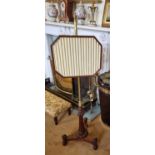 Of Superb quality. An early 19th Century Pole Screen with a brass shaft on turned reeded supports