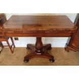 An early 19th Century Rosewood Foldover Card Table on hexagonal shaft platform base and turned