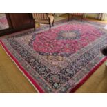 A large rich ground Pink/Red ground Iranian Kerman Carpet with central medallion design. 380 x 295cm