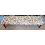 A good Mahogany showframe long Footstool on turned supports with tapestry style upholstery. 105 x 29