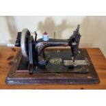A Vintage Rhodes and Sons sewing Machine in Walnut case. 51 x 28cm approx.
