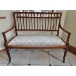 An Edwardian Mahogany and Inlaid two seater Couch with square tapered supports and bow front with