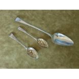 A large Georgian basting Spoon, c1800 123 gms approx along with two Georgian berry Spoons c1821.