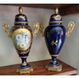 A good pair of Limoges hand painted Urns with lids and ormolu mounts. H 30 cm approx.