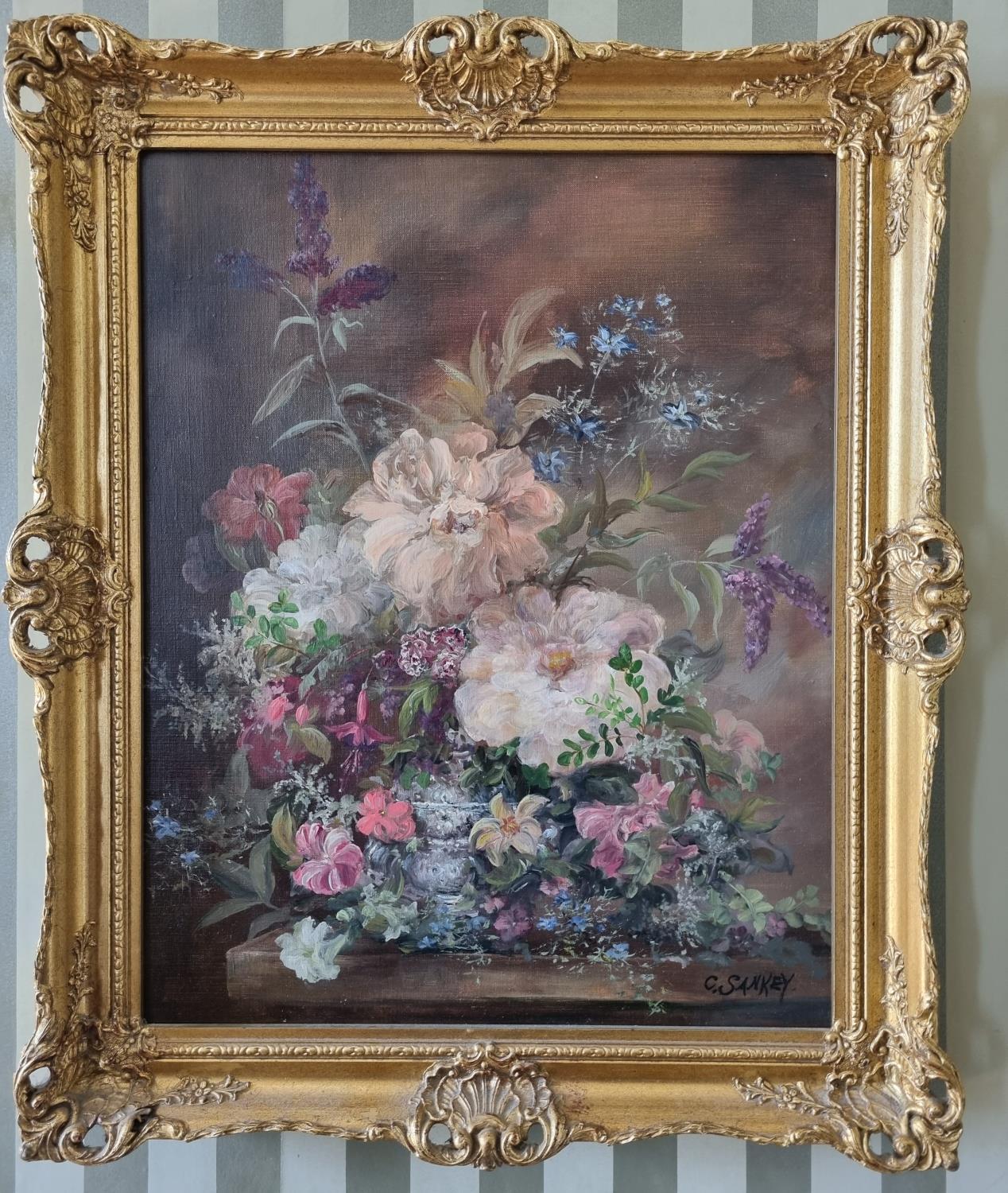 An early 20th Century Oil on Canvas still life of flowers in a vase on a table setting. Signed C