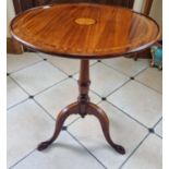 An Edwardian Mahogany and Inlaid circular Supper Table with a shell inlay top, on turned tripod