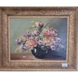 A 20th Century Oil on Canvas still life of flowers in a table setting. Indistinctly signed LL. 28