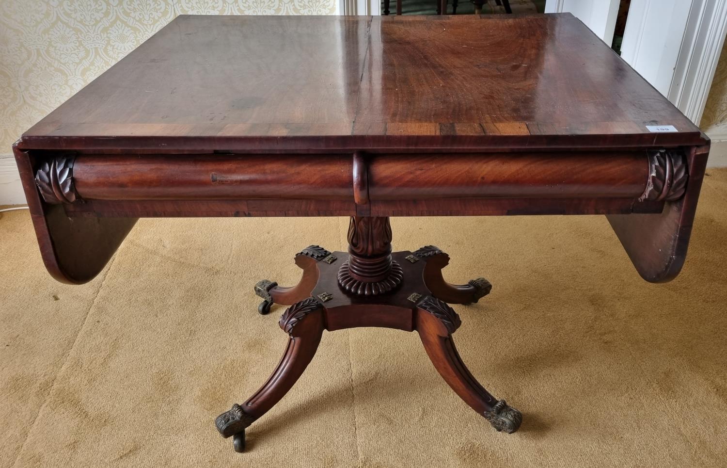 A Magnificent Irish early Regency Mahogany Sofa Table with rosewood crossbanding and carved acanthus