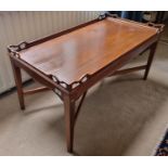 A 20th Century Mahogany Butlers Tray in the style of a table with square tapered supports and