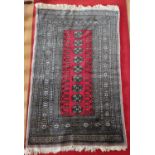 A good grey and red ground Rug with repeating medallion centre design and multi borders. 134 x