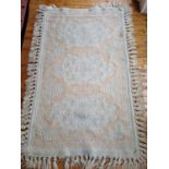 A Cream ground Rug. 115 x 175cm approx.