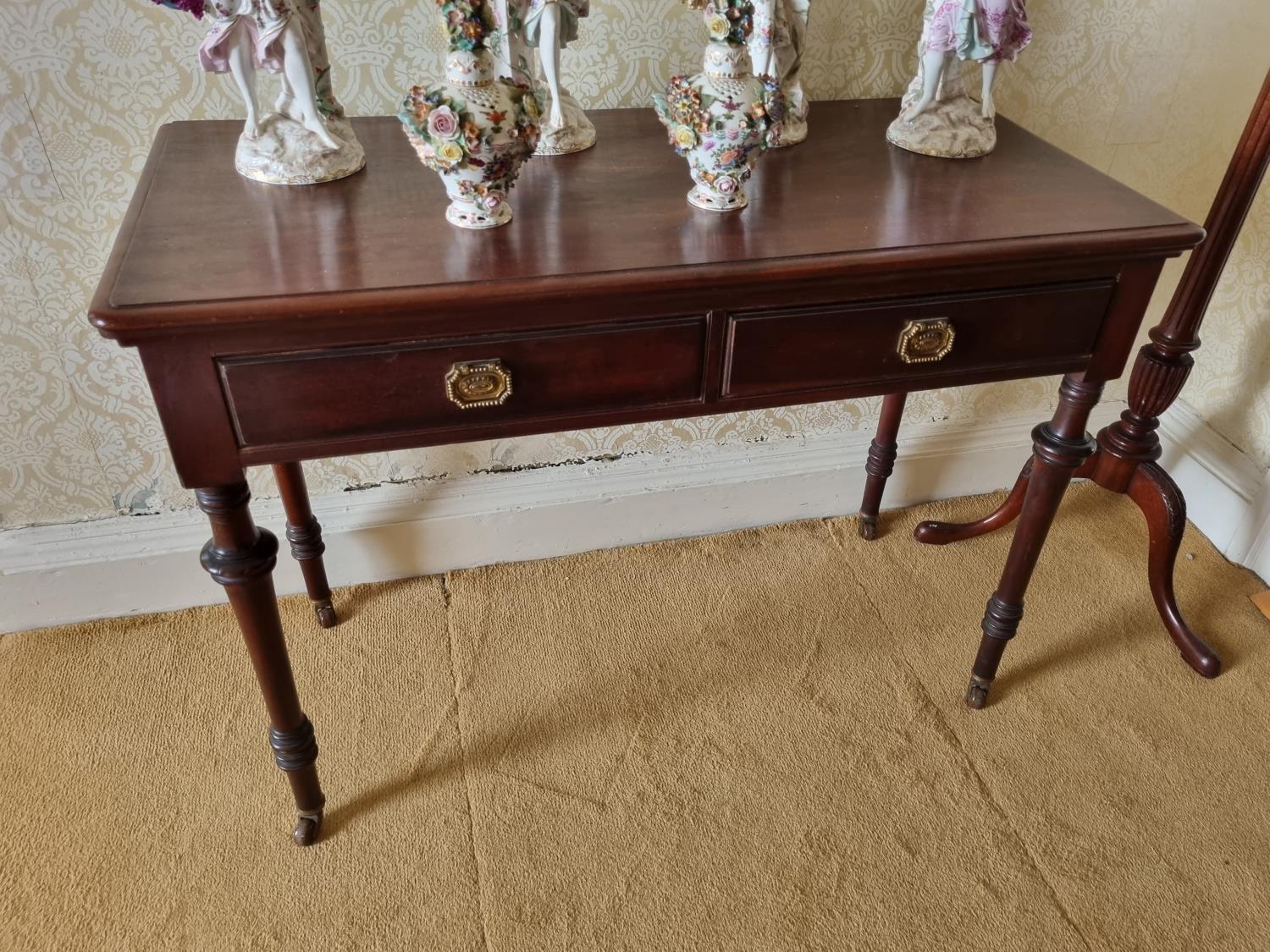 A good late 19th early 20th Century Mahogany two door Side Table on turned supports and brass