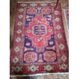 A Persian Red ground Rug. 172 x 114 cm approx.