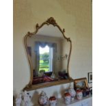 A 20th Century Timber and Plaster Gilt Overmantel Mirror with cartouche carved top. 134 x 108 cm