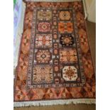 A good red ground Persian Rug with repeating centre panel design and multi borders. 210 x 123cm