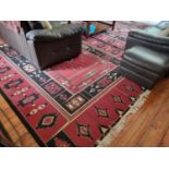 A red ground modern Carpet with Aztec style design. 240 x 340 cm approx.