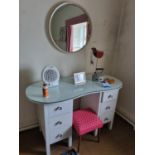 A modern kidney shaped Desk with glass top along with a stool and a mirror and other items. 126 x