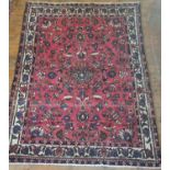 A Red ground Iranian village Rug from the Bakthia region. 278 x 180cm approx.