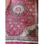 A good Persian Tabriz red and cream ground Rug with multi borders and unique central medallion