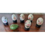 A good group of five hand painted Oriental eggs along with another example.
