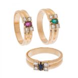 Set of three 18kt yellow gold rings. Featuring a ruby, emerald and central navette-cut sapphire