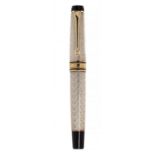 CARLO GOLDINI" DELTA FOUNTAIN PEN.Silver barrel and ornamentation and details in gold and black.