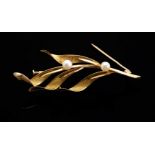 Brooch in 18kt yellow gold. Floral design model formed by a branch with articulated leaves of