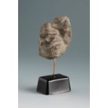 Fragment of a grotesque head. Smyrna, 3rd century BC.Terracotta.Provenance: Smyrna, 1895-1905.
