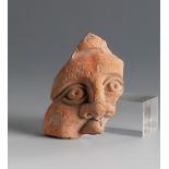 Fragment of a head. Smyrna, 3rd century BC.Terracotta.Provenance: Smyrna, 1895-1905. Collection Paul