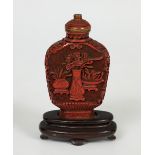 Snuff bottle; China, 20th century.Carved lacquer. Wooden base.Measurements: 9 x 5.5 x 2 cm.This type