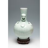 Celadon-type vase after Ming dynasty models. China, 20th century.Celadon-type porcelain. Wooden