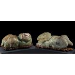 Pair of Foo dogs; China, 19th century.Carved serpentine stone.One of the pieces has damage to the