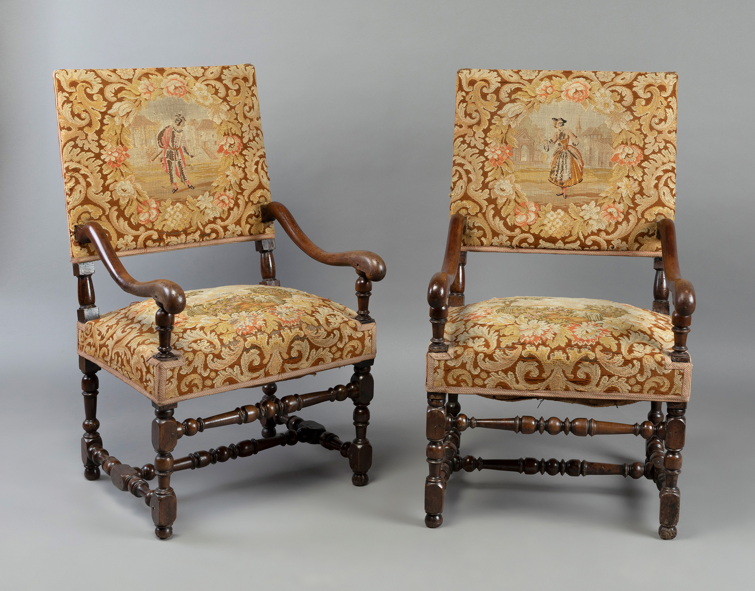 Pair of Louis XIV armchairs. France, 17th-18th century.Walnut wood and petit point upholstery.Use