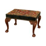English, 19th Century, a mahogany stool upholstered with early needlework