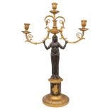French Empire, A pair of patinated brass and ormolu figural candlesticks