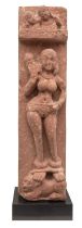 Central Indian, 10th - 13th Century, A red stone carving of a female deity with shackled feet