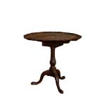 Early 19th Century, A tilt-top tripod mahogany wine table with carved shell motif