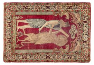 Persian, c. 1910, A kirman rug with an archaeological motif bearing the word 'Persepolis'