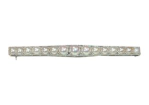 Edwardian, A natural split pearl and white gold graduated bar brooch