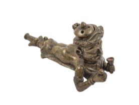 India, 18th Century, A figural bronze opium pipe in the form of a supine male figure holding a bell