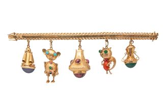 An attractive 1950s gold charm bracelet with five large gem set charms