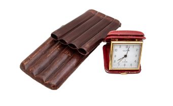 NO RESERVE: A Luxor travelling clock covered in red leather, and a vintage leather cigar holder